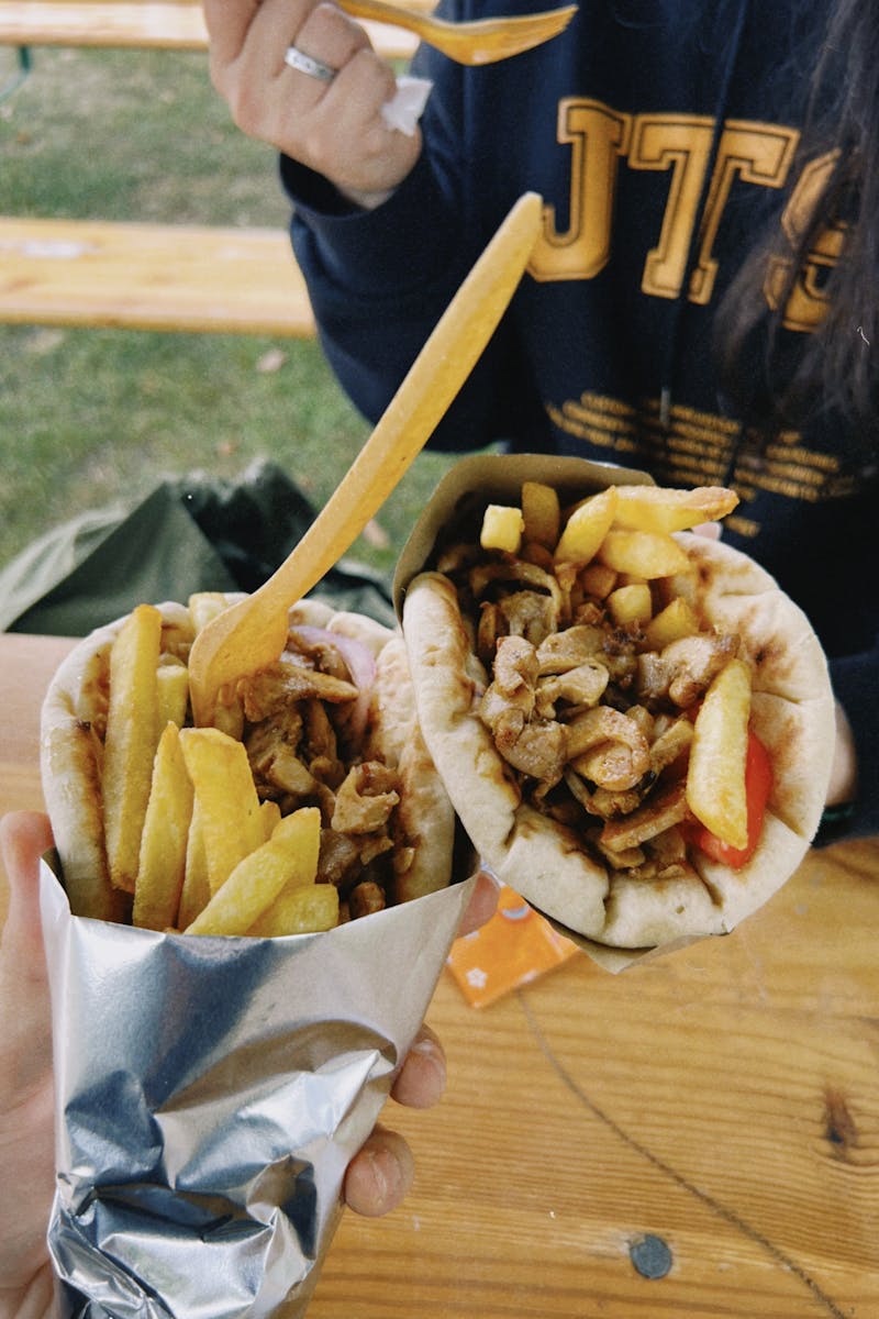 Two delicious gyros with fries enjoyed outdoors in vibrant Warsaw.